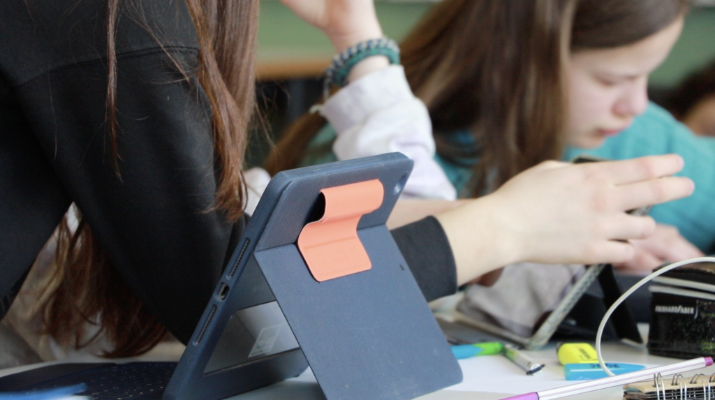 School children learning with tablets.